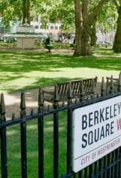 View of Berkeley Square with its lush greenery and iron railings, featuring a prominent self storage street sign in the foreground.
