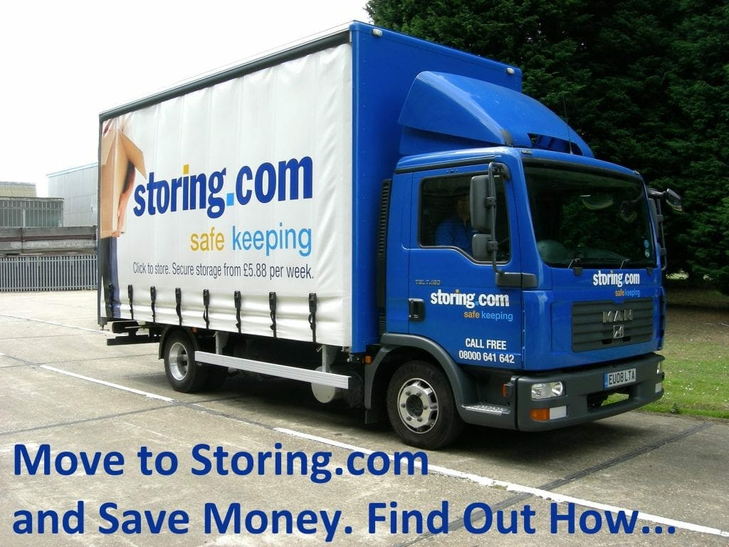 A blue and white self storage company truck parked in a lot with promotional text and website details on its side.