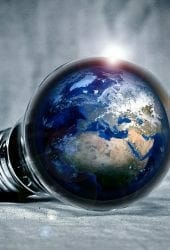 A light bulb with the earth globe inside it, illuminating brightly on a textured self-storage surface.