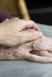 older couple holding hands