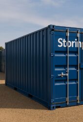 Blue storage containers on a gravel path, with a church steeple visible in the background on a clear day.